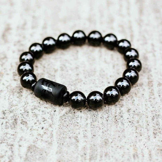 Black obsidian bead bracelet with smooth barrel charm center