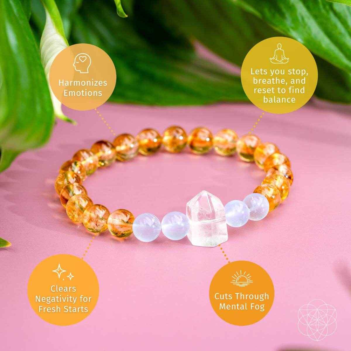 Gold and white beaded bracelet laid flat with crystal charm