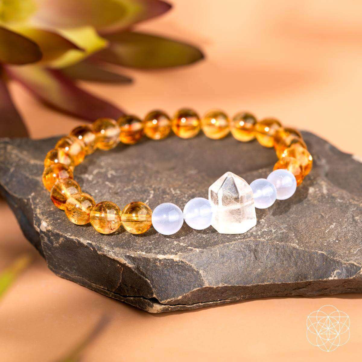 Gold and white crystal beaded bracelet on slate stone