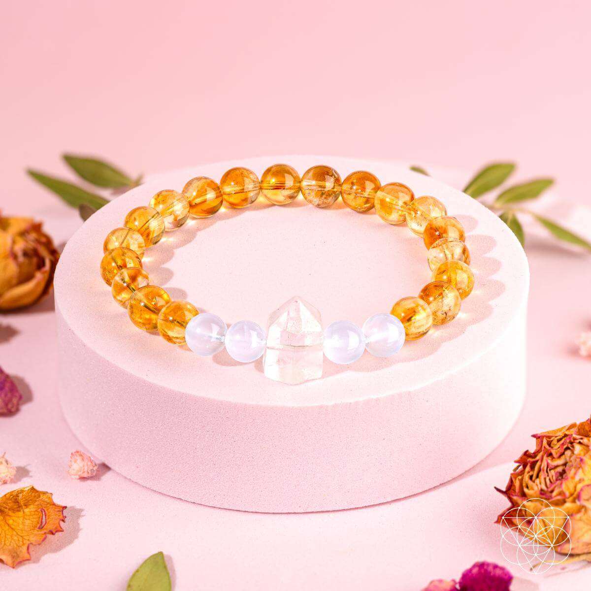 Gold and white beaded bracelet with crystal centerpiece on stand