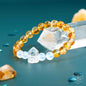 Gold beaded bracelet with white beads and faceted crystal charm