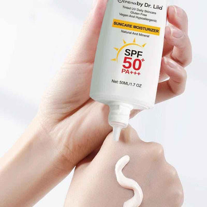 White SPF 50 mineral moisturizer tube dispensing cream from nozzle onto hand