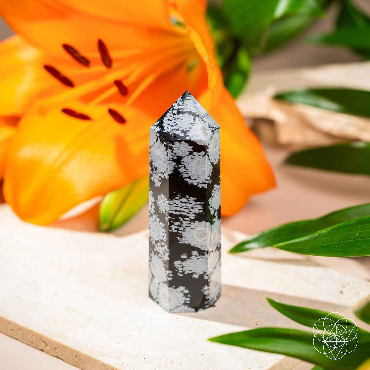 Snowflake obsidian point crystal, black and gray with scattered white snowflake markings