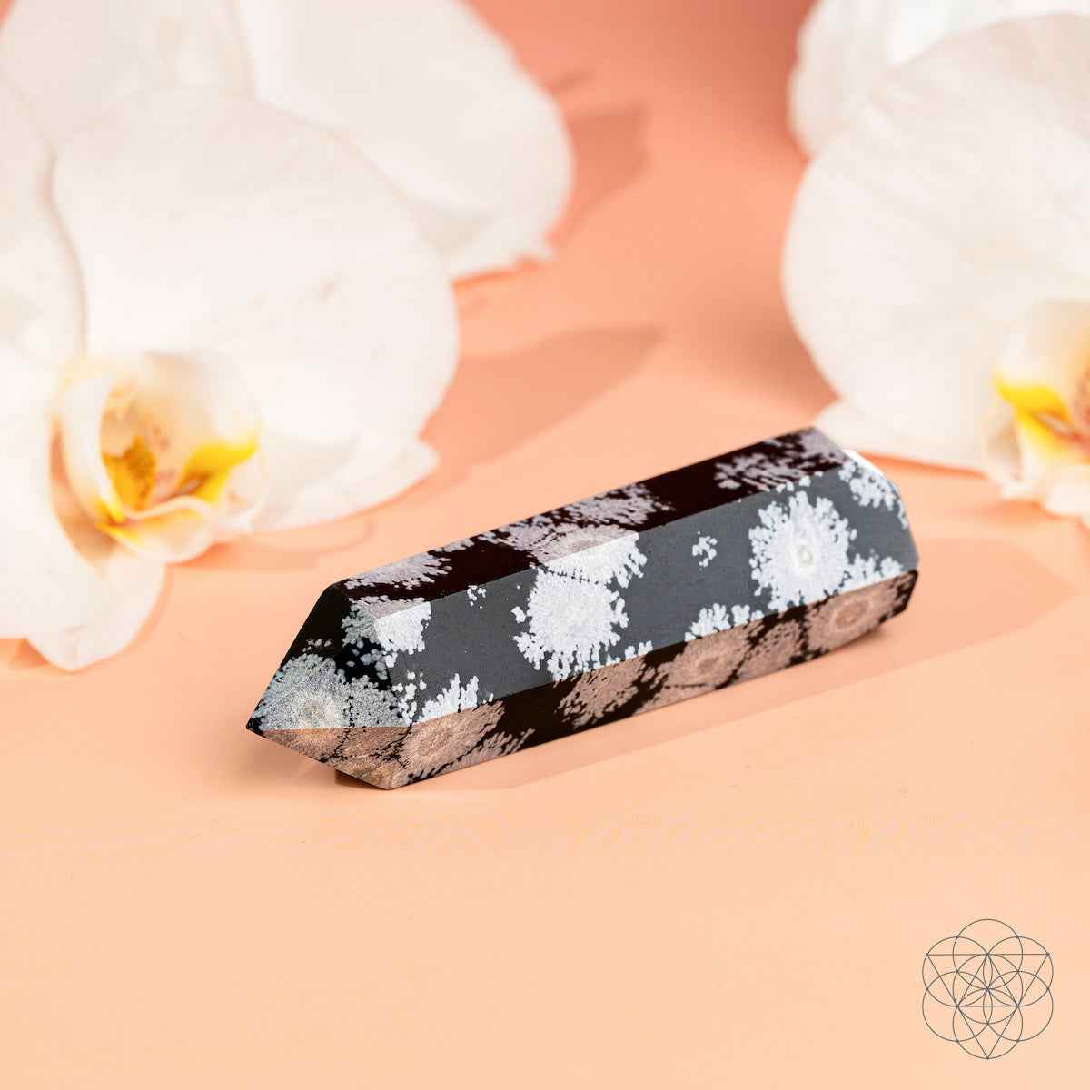 Snowflake obsidian point crystal, black with white speckled pattern and sharp tip