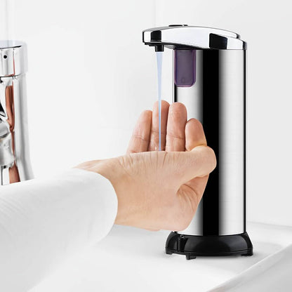 Automatic soap dispenser on countertop with chrome top, purple window, and hand over the nozzle