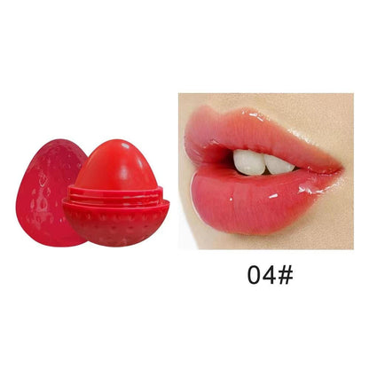 Red strawberry-shaped lip butter balm with open cup and rich lip color swatch