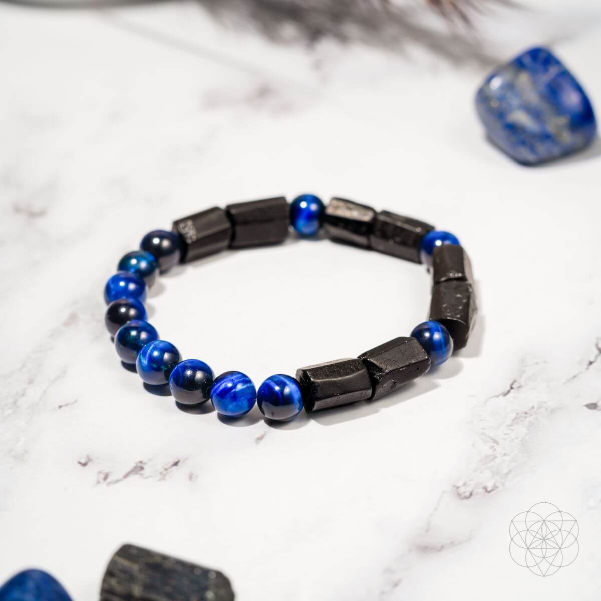 Blue-and-black beaded bracelet with dark rectangular segments and round blue beads