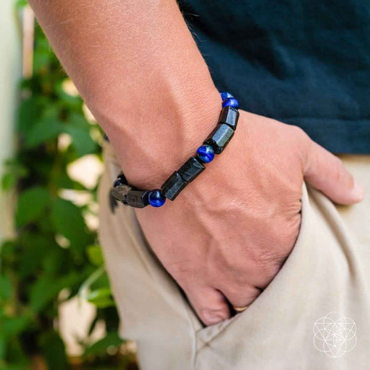 Blue beaded bracelet on wrist with black rectangular links
