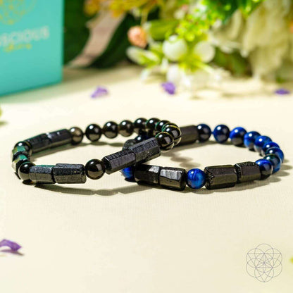 Multiple blue-and-black beaded bracelets with black center spacers