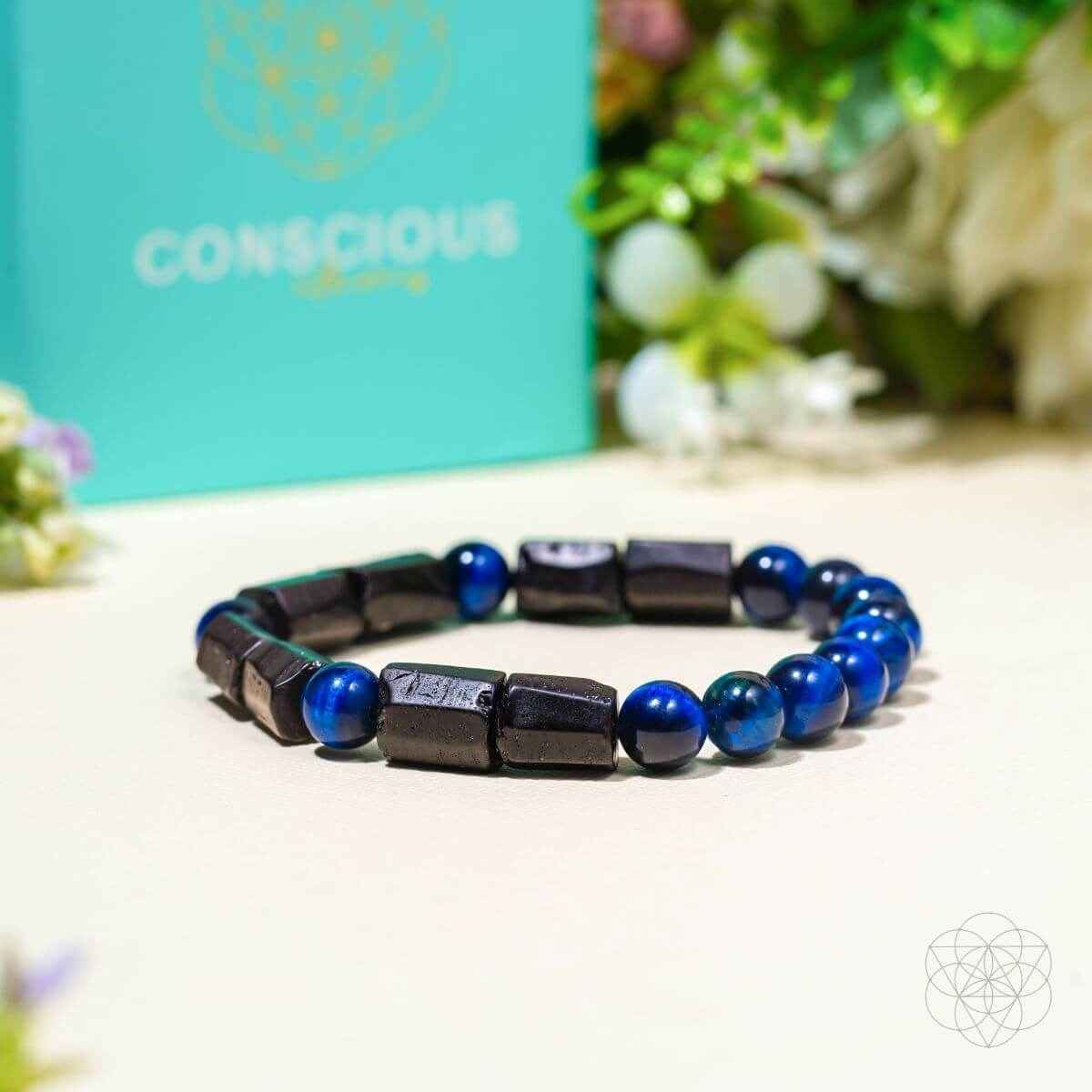 Blue-and-black beaded bracelet with dark rectangular beads and blue round beads