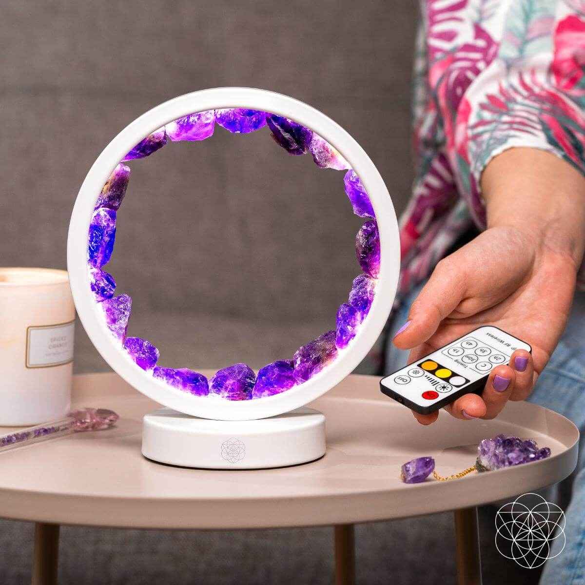 White amethyst healing lamp with purple crystal ring, showing remote control