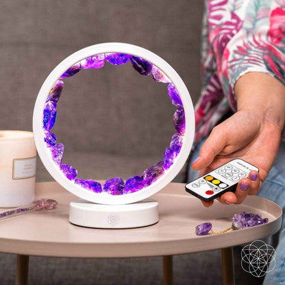 White amethyst healing lamp with purple crystal ring, showing remote control