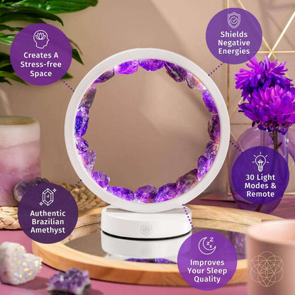 White amethyst healing lamp with purple crystal ring glow on wooden surface