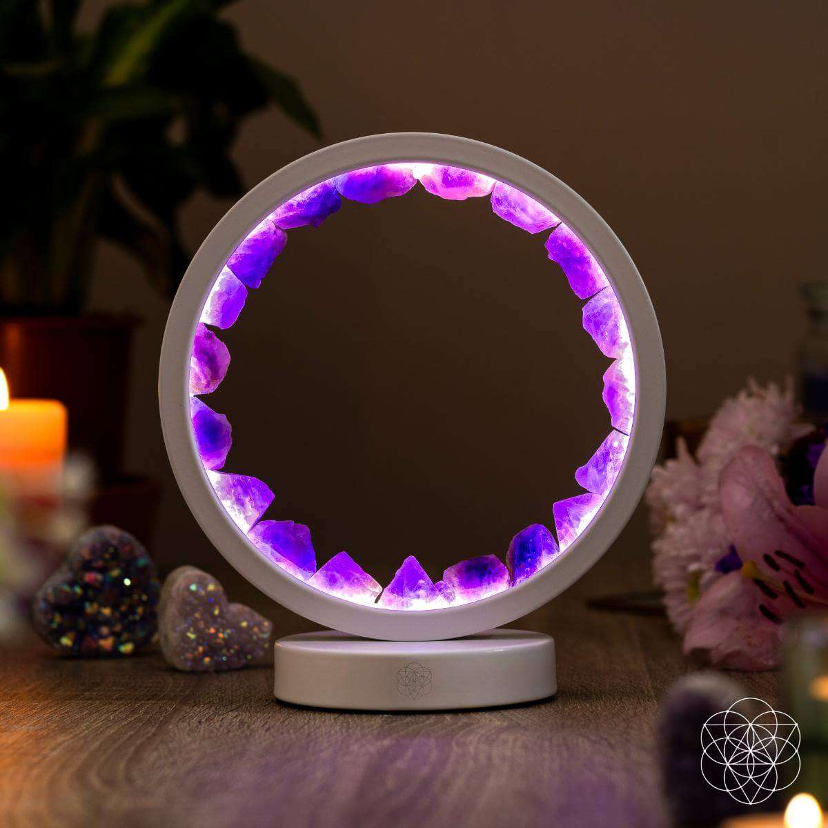 White amethyst healing lamp with glowing purple crystal ring on round base