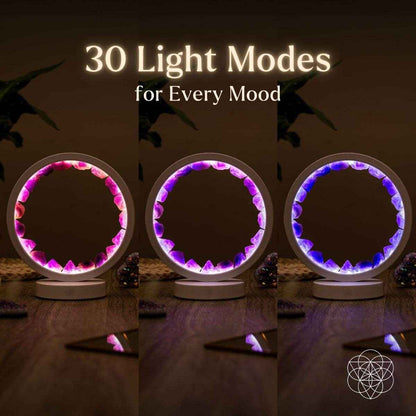 Three glowing amethyst healing lamps with purple crystal rings on round bases