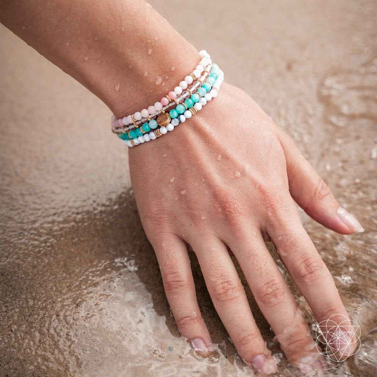 Turquoise and white beaded bracelet set on wrist with small gold spacer beads
