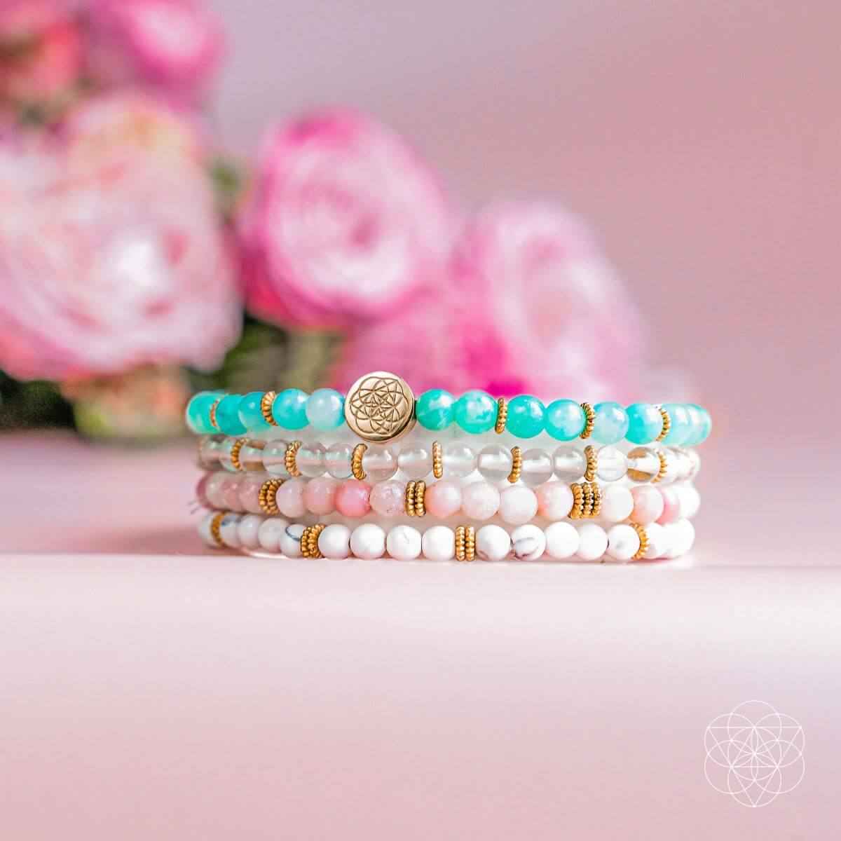 Beaded stress-relief bracelets stack with gold flower charm and turquoise and white beads