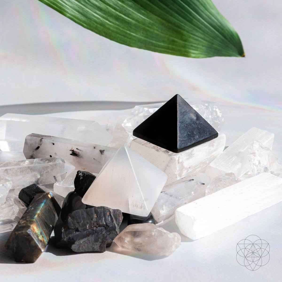 Black and off-white pyramid crystals among clear and white quartz pieces