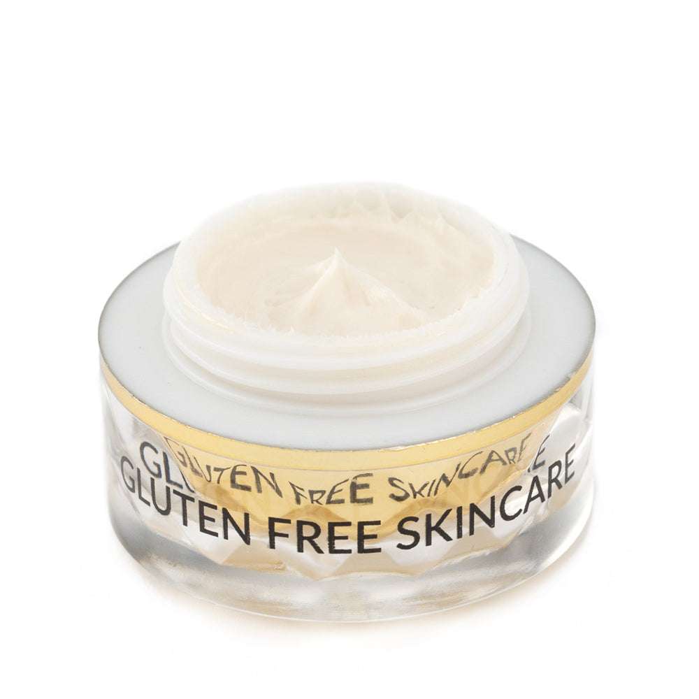 Gluten-free eye cream jar with pale cream inside and gold rim