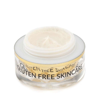 Gluten-free eye cream jar with pale cream inside and gold rim