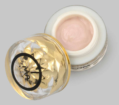 Eye cream jar with open lid and pale pink cream inside, gold base