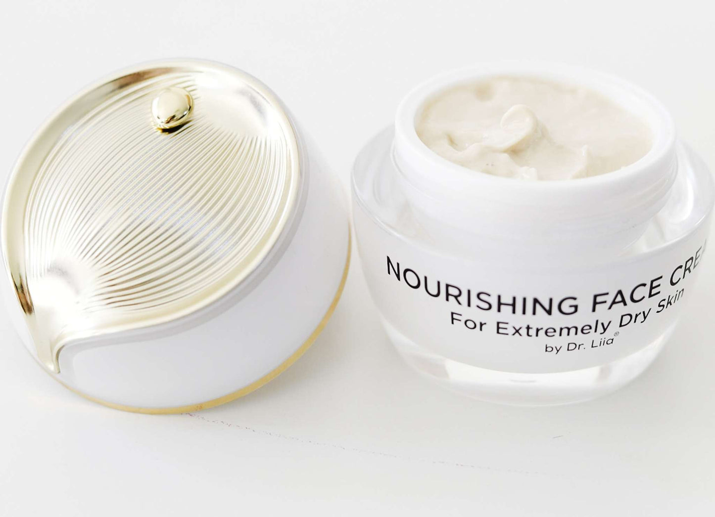 Two face cream jars, one open with cream visible
