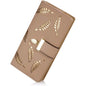 Beige long bifold wallet with leaf-pattern cutouts and metal clasp tab