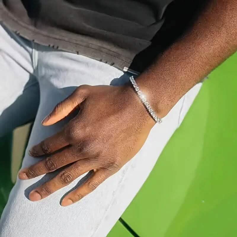Silver-tone tennis bracelet with clear stones on hand and wrist