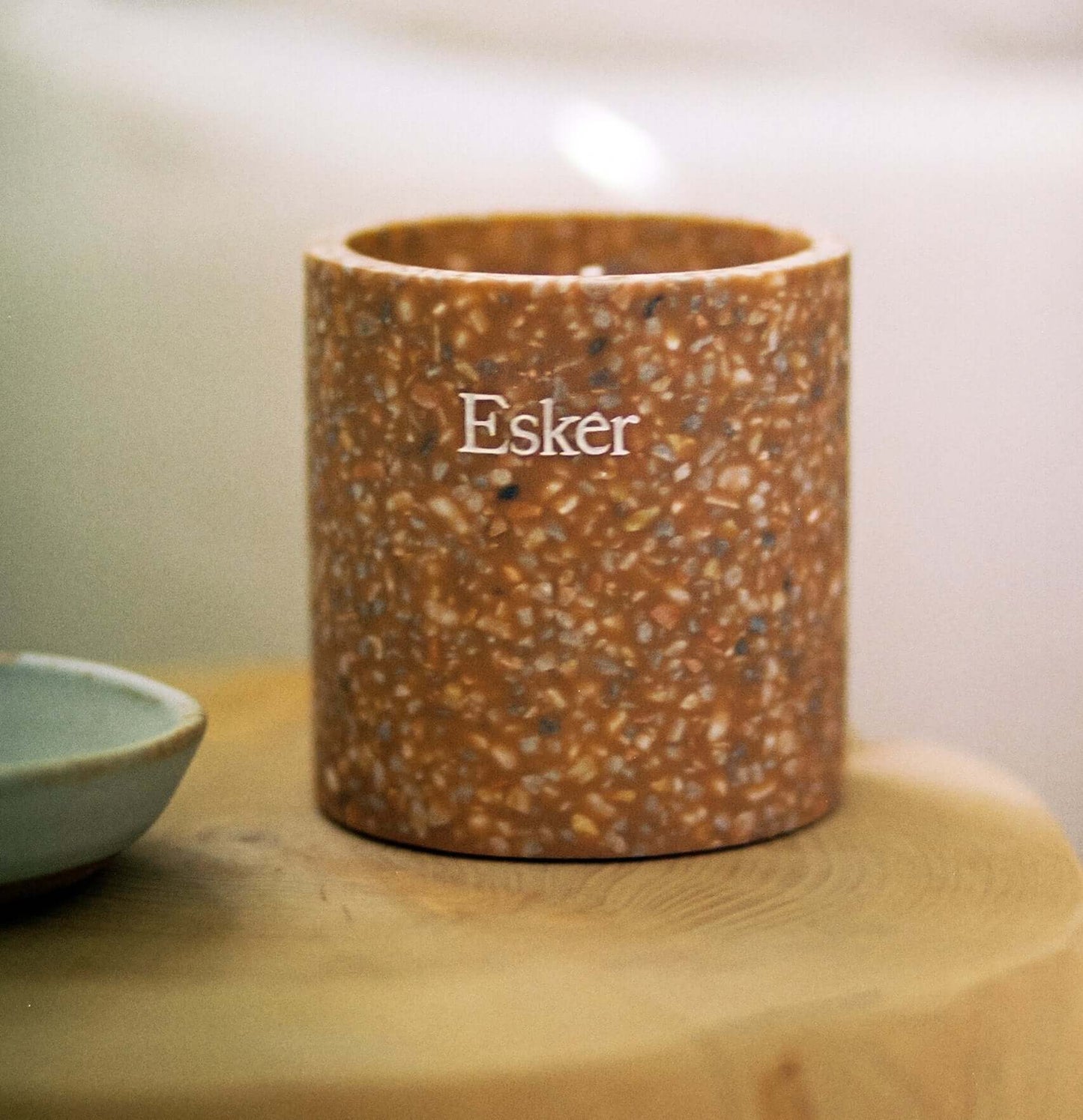 Plantable terracotta candle with Esker label, close-up on speckled jar
