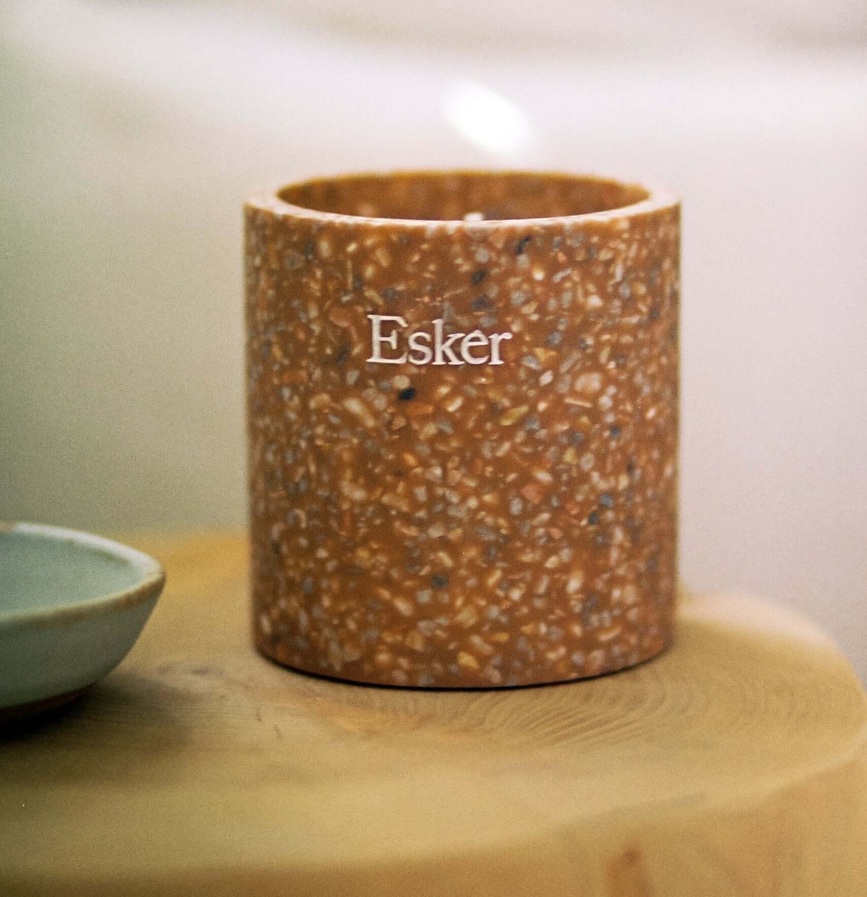 Plantable terracotta candle with Esker label, close-up on speckled jar