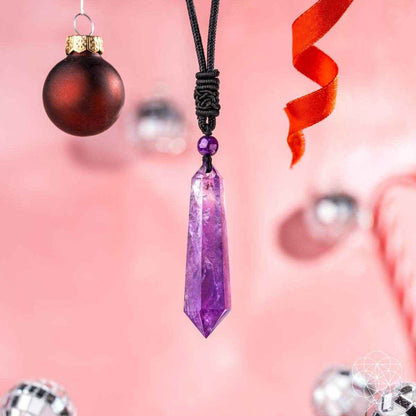 Amethyst crystal pendant necklace with black cord and red ornament