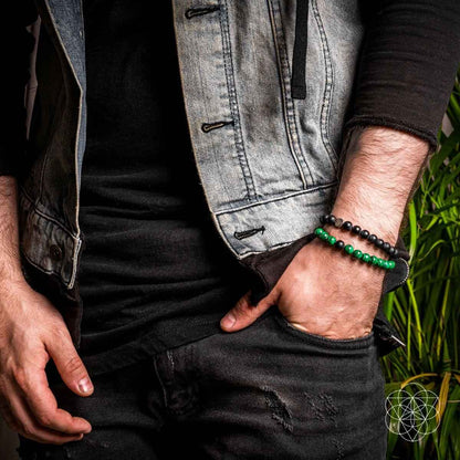 Double beaded bracelet on wrist with black beads and green bead strand