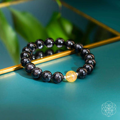 Deep healing bracelet with dark beads and a yellow crystal charm