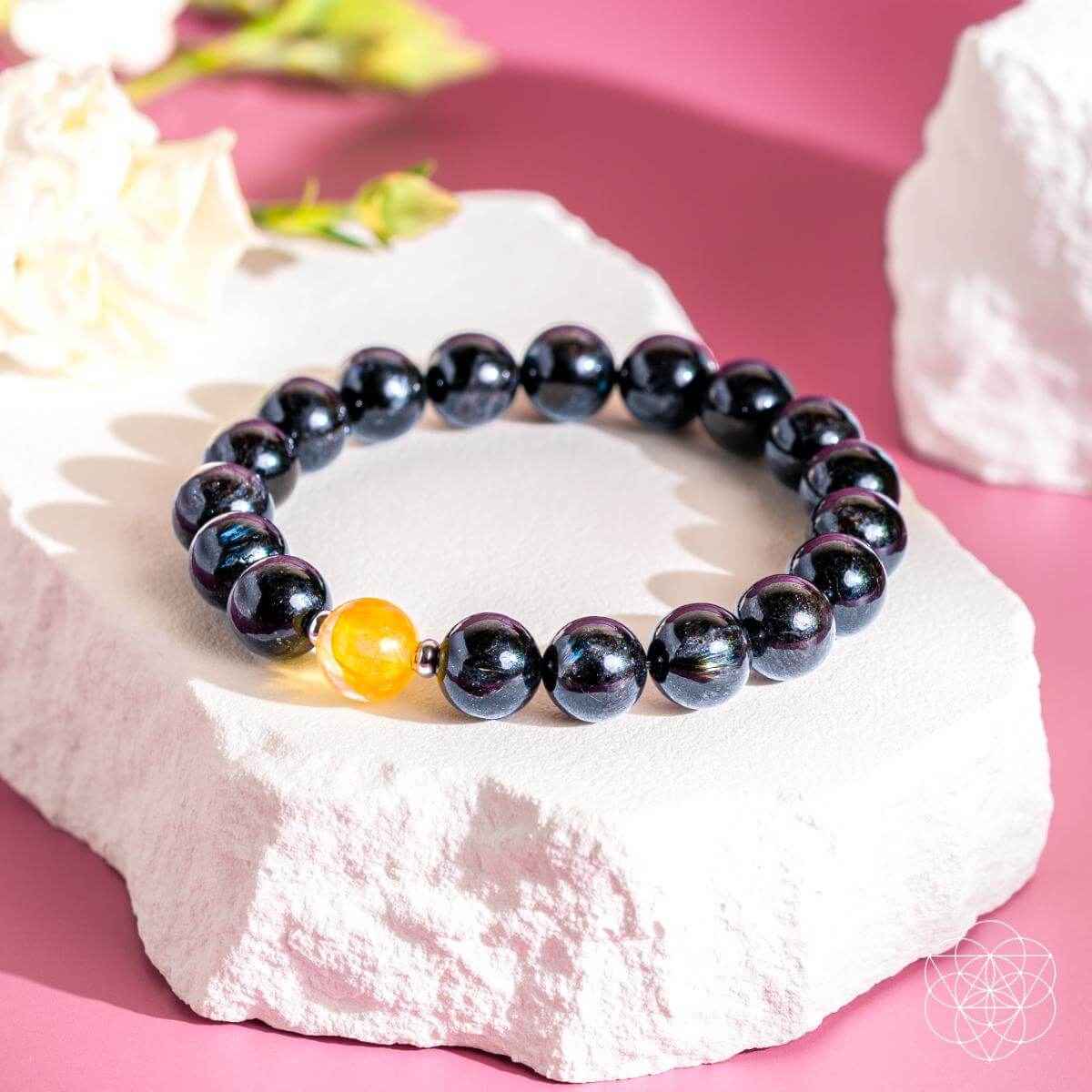 Deep healing bracelet with dark iridescent beads and a yellow round accent bead