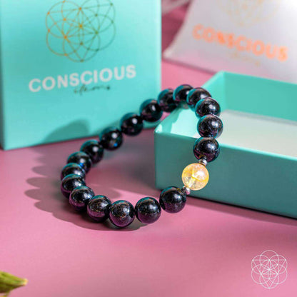 Deep healing bracelet with dark beads and a yellow crystal pendant bead