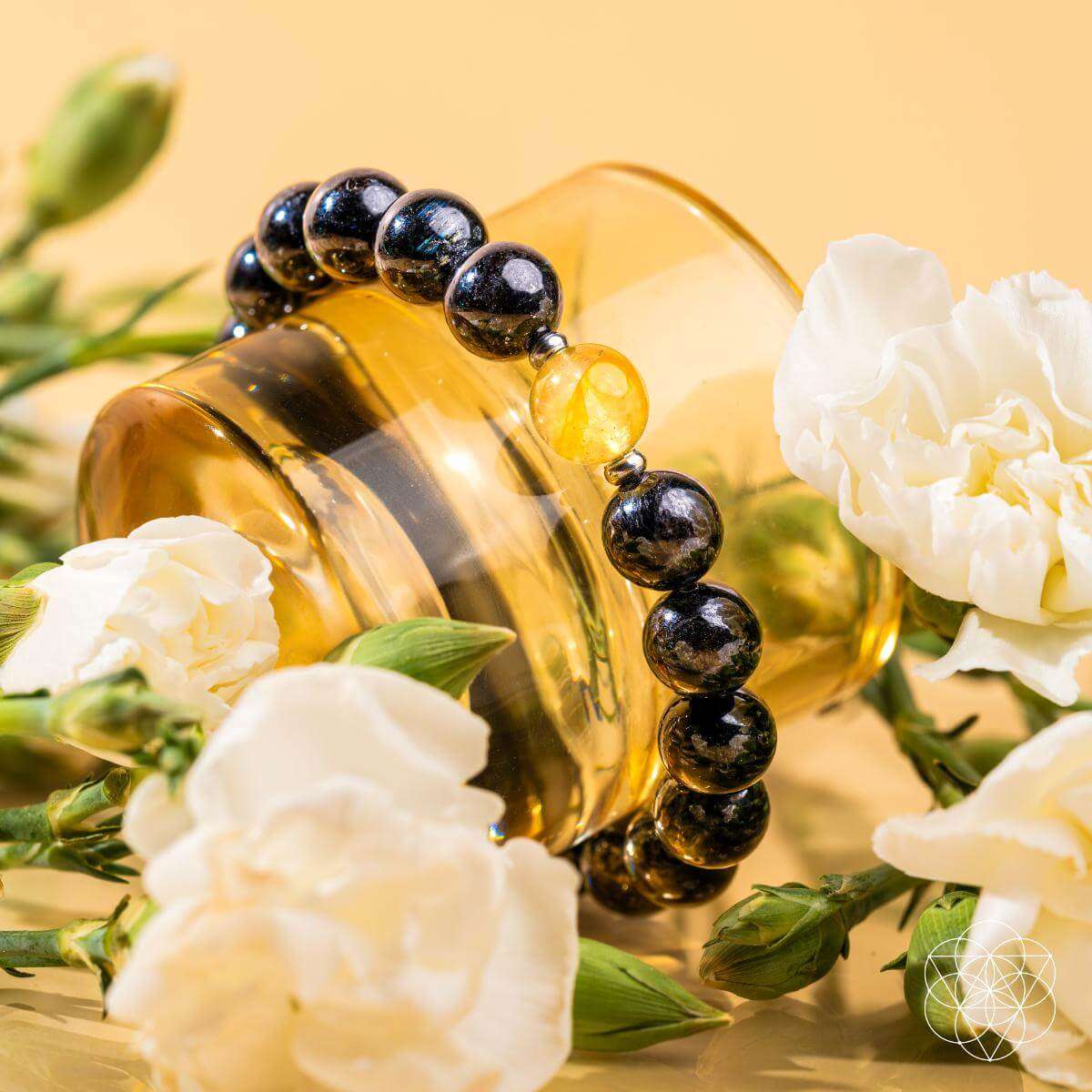 Beaded bracelet with dark stones and a yellow crystal center detail