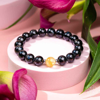 Deep healing bracelet with dark beads and a yellow crystal accent bead