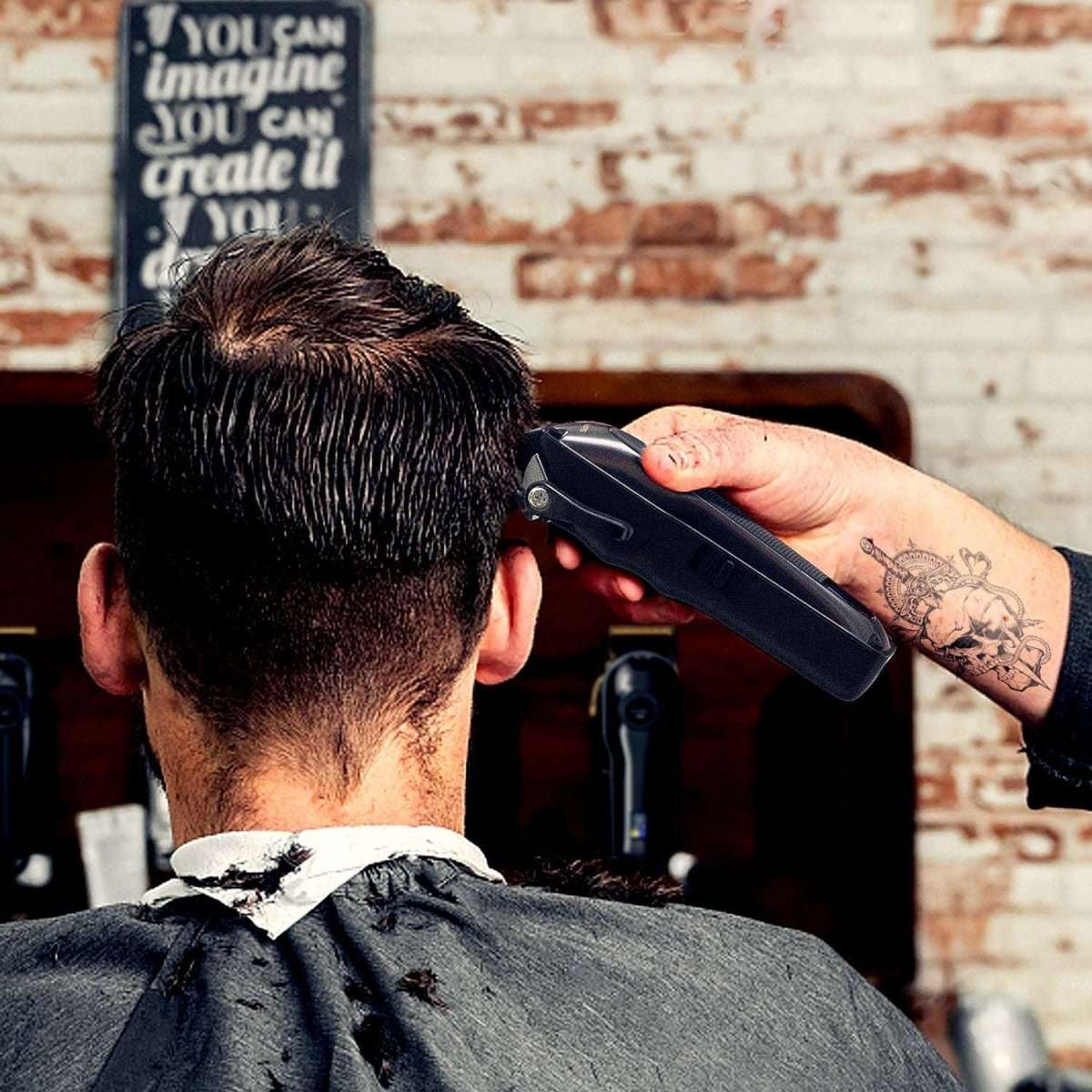 Hand trimming hair with a black hair clipper in a barbershop close-up
