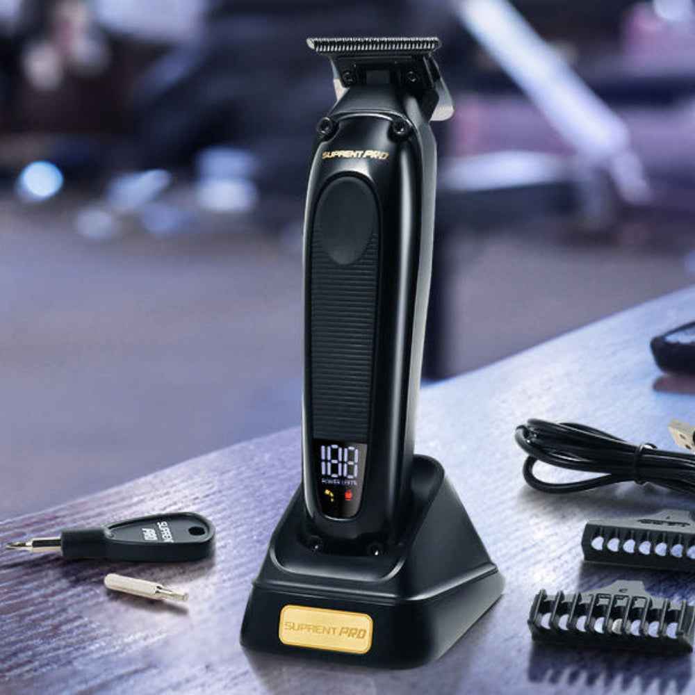 Professional hair trimmer on stand with spare comb guards and charging cable