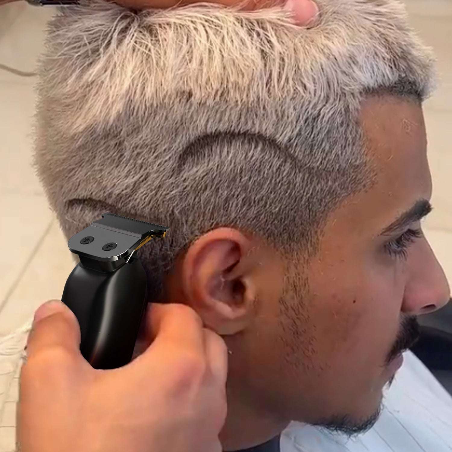Black hair trimmer trimming a faded haircut on the side of the head