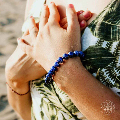 Blue beaded bracelet with round stones, close-up on wrists and hands
