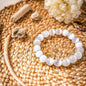 White beaded cleansing bracelet with smooth round stones