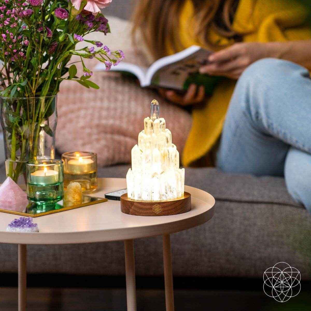 Clear quartz manifestation tower lamp glowing crystal stack on wooden base