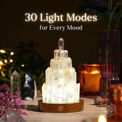 Clear quartz manifestation tower lamp with lit crystal pillar on round wooden base