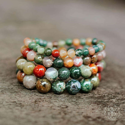 Multicolor gemstone bead bracelets with round beads in green, red, orange, and neutral tones