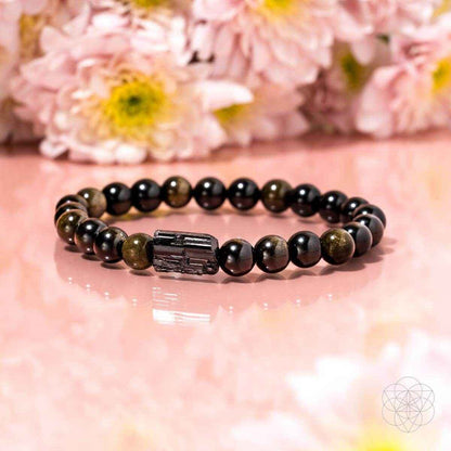 Energy protection bracelet with dark beads, rectangular charm, and small greenish bead accents