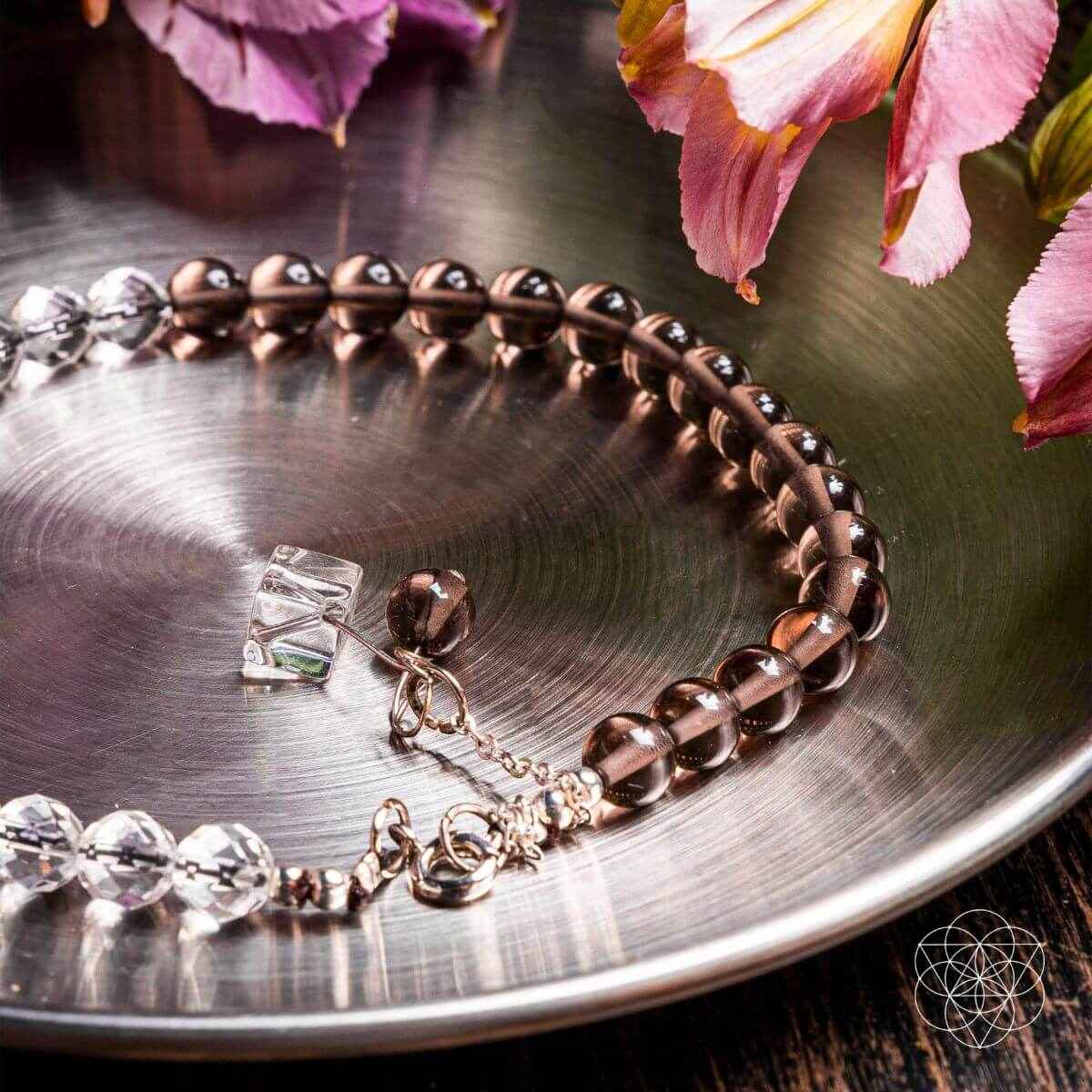 Copper-brown bead and silver-tone anklet with dangling crystal charms, close-up
