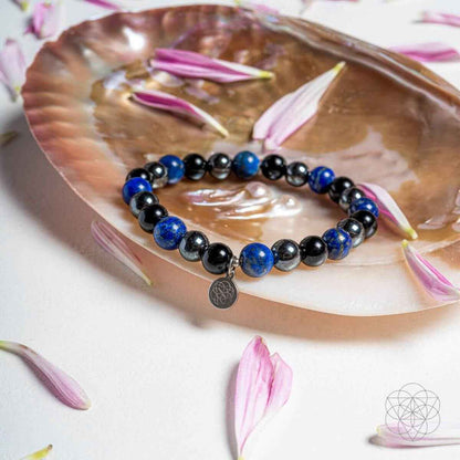 Blue and black beaded energy-shield bracelet with round silver charm