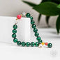 Green beaded law of attraction bracelet with pink and gold charm accents