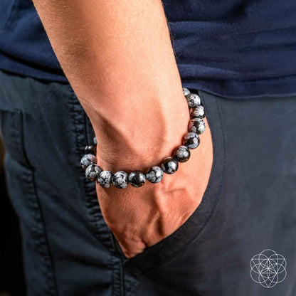 Snowflake obsidian beaded bracelet on hand, black and gray speckled round beads